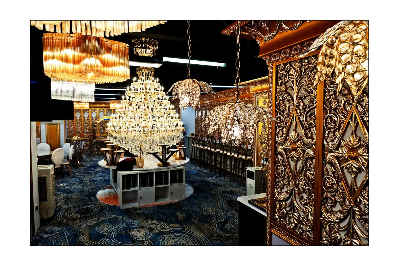 Carved gold wall panelling and a crystal chandelier